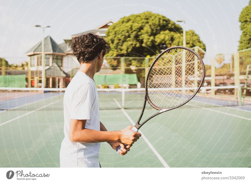 young boy holing tennis racket and playing sport Lifestyle Joy Playing Summer Sports Human being Man Adults Friendship Partner Fitness Green