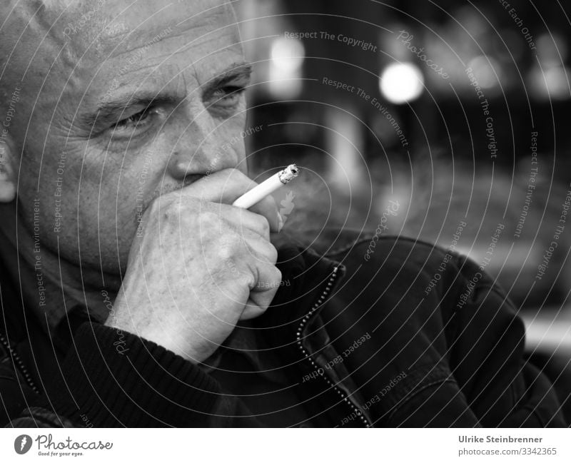 Man smoking a cigarette while lost in thought Healthy Smoking Contentment Relaxation Restaurant Going out Human being Masculine Adults Life Head 1 45 - 60 years