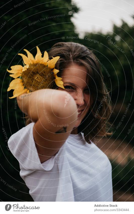 Carefree resting woman with sunflower summer flora nature light female forest standing vacation carefree freedom relaxing tourism travel lifestyle young