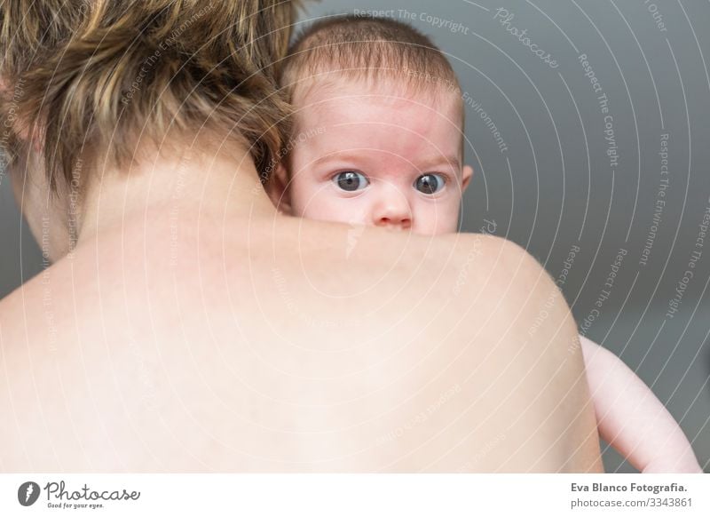 Back view of a A Happy mother holding her adorable child baby girl Baby Cute Small Portrait photograph Child Infancy Beautiful Face Girl Innocent blue eyes