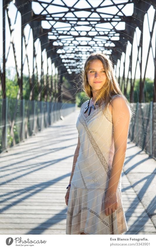 outdoors portrait of a beautiful young woman Portrait photograph Youth (Young adults) Woman Exterior shot Happy Blonde blue eyes Bridge Summer Sunbeam Hair