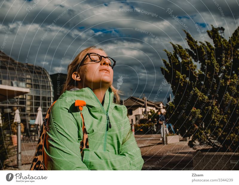 Woman enjoys the sun Town Village Sun To enjoy Sightseeing Storm clouds Sunbeam Warmth be comfortable Relaxation vacation holidays South relax Wait Jacket