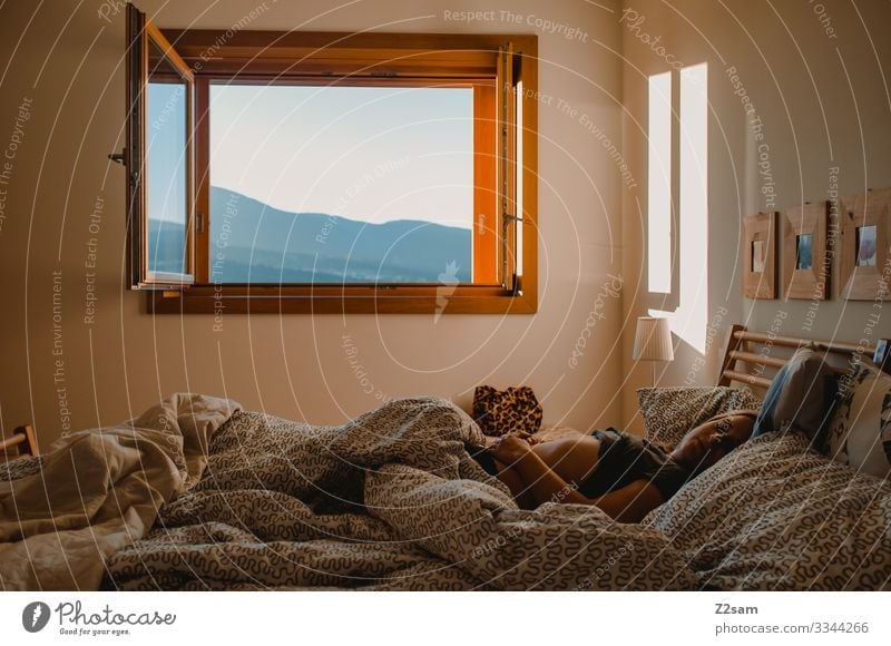 Young woman Morning in bed Sleep Arise Bed Bedroom Fatigue Bedclothes Wake up Duvet Relaxation Colour photo Blanket Dream Oversleep Interior shot Alert Lie
