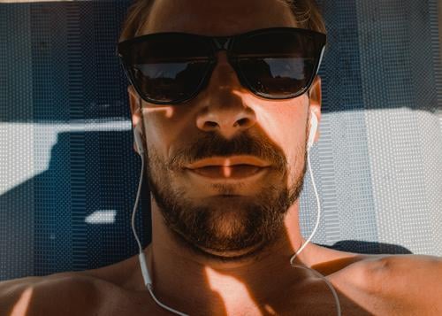 Chilling and listening to music on holiday Headphones Lie vacation Facial hair Man Young man Couch sunglasses Summer Summer vacation sun lounger portrait