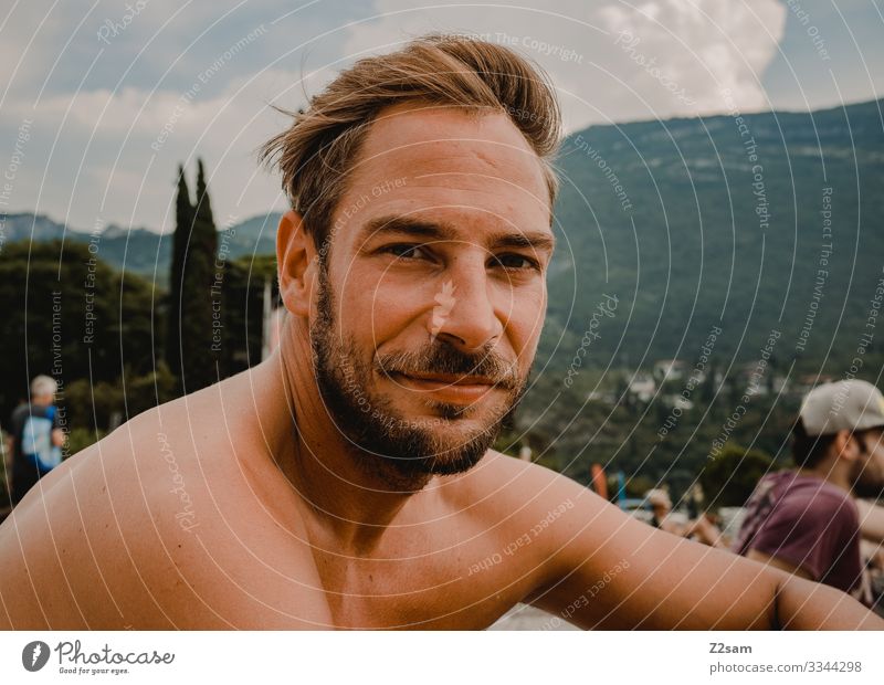 Man chilling on the beach in Torbole Lake Garda Beach Relaxation contented fortunate Freedom free time vacation mountains portrait Facial hair youthful