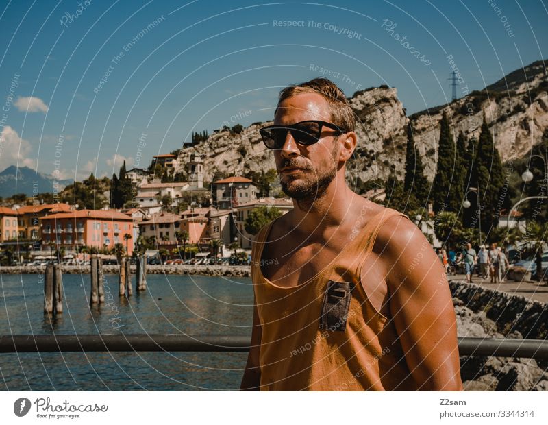 Young man on holiday | Torbole Lake Garda Man Beach Lakeside mountains Mountain Exterior shot Water Italy Nature Landscape Summer Harbour Village Town