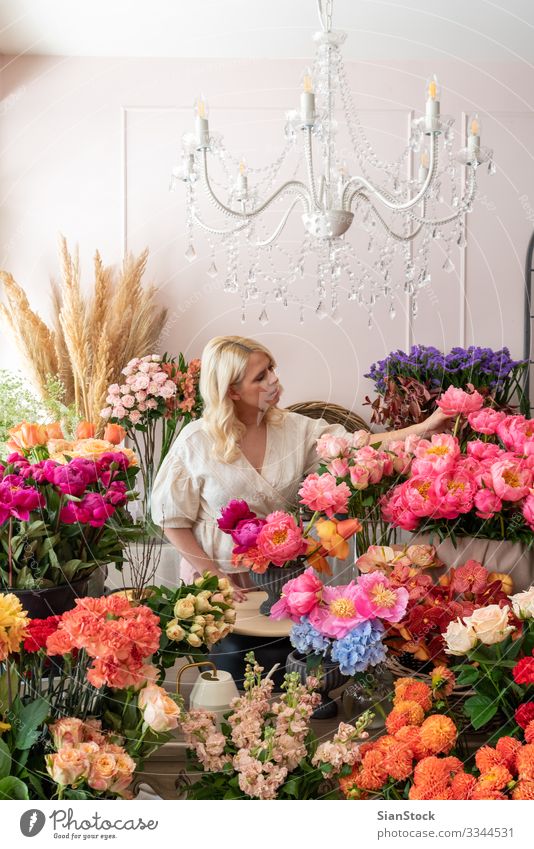 Beautiful blonde florist woman creates wonderful bouquet Lifestyle Human being Nature Flower Blossom Happiness Enthusiasm Euphoria Colour photo Morning Day