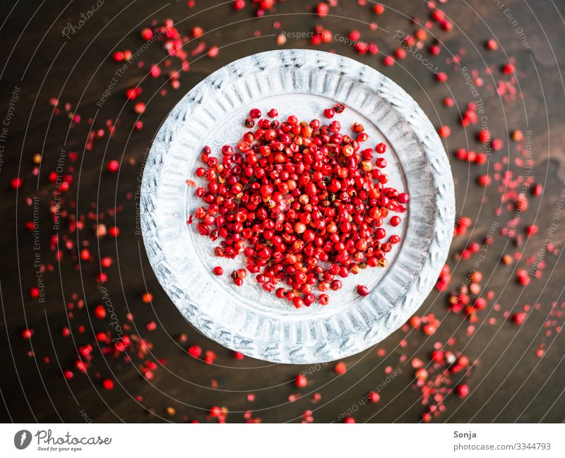 Red dried pepper on a silver plate Food Herbs and spices Peppercorn Organic produce Plate Healthy Wooden table Fragrance To enjoy To dry up Exceptional
