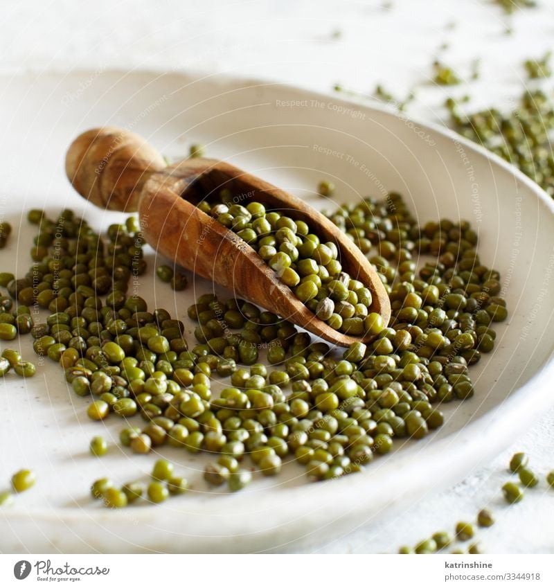 Dried mung beans with a spoon on a plate Vegetarian diet Diet Plate Spoon Table Green White Beans close up details fiber food health healthy Ingredients legume