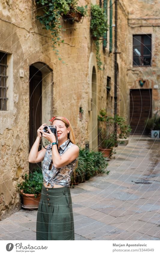 Young woman taking photo in an old town in Italy Lifestyle Vacation & Travel Tourism Trip Sightseeing City trip Camera Human being Feminine Youth (Young adults)