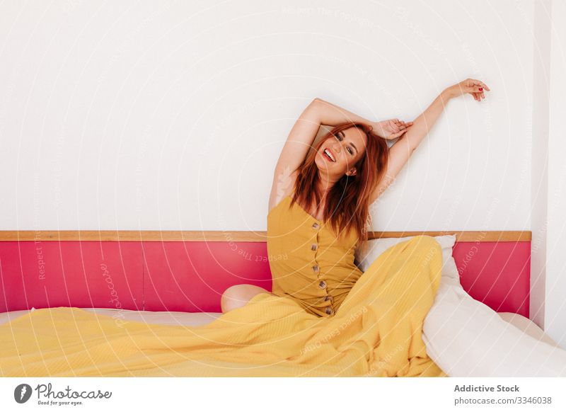 Pleased woman in stylish gown at home smile enjoy style dress yellow happy beautiful young female redhead casual lifestyle pretty positive relaxation freedom