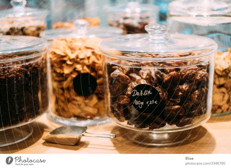 Glass jars with dried fruits in a supermarket without packaging Supermarket package-free Glass container Date Food Shopping Sustainability plastic-free