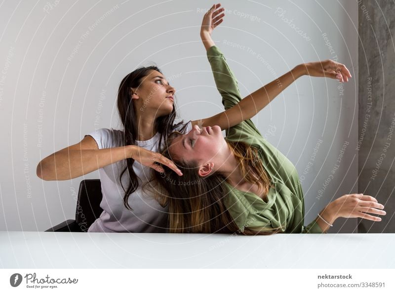 Two Women Posing Artistically at Bureau 6 Desk Dance Office Woman Adults Friendship Youth (Young adults) Youth culture Sit Conceptual design arms raised