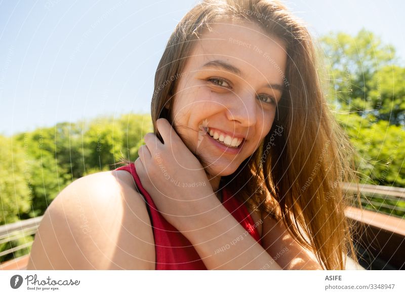 Portrait of a happy young woman enjoying nature in a sunny day Lifestyle Joy Happy Beautiful Face Relaxation Leisure and hobbies Summer Sun Woman Adults