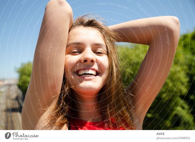 Laughing teen girl enjoying the sun in the city Lifestyle Joy Happy Beautiful Relaxation Leisure and hobbies Summer Sun Woman Adults Youth (Young adults) Arm
