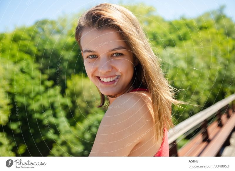 Portrait of a happy beautiful teen girl smiling in a sunny day Lifestyle Joy Happy Beautiful Face Relaxation Leisure and hobbies Summer Sun Woman Adults