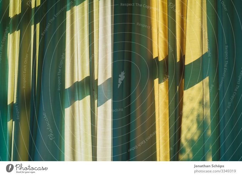 Curtain with shadow from window Drape Window Shadow Green Yellow Window transom and mullion Shadow play Pattern background crease Sunlight sun protection warm