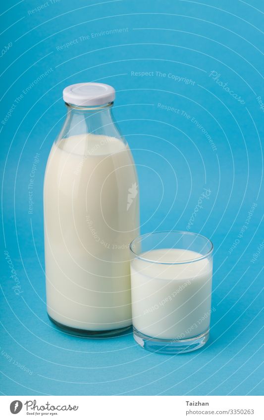 Bottle with milk and glass of milk Breakfast Diet Lifestyle Table Nature Old Fresh Bright Delicious Clean Blue White Tradition calcium drink Ingredients Organic