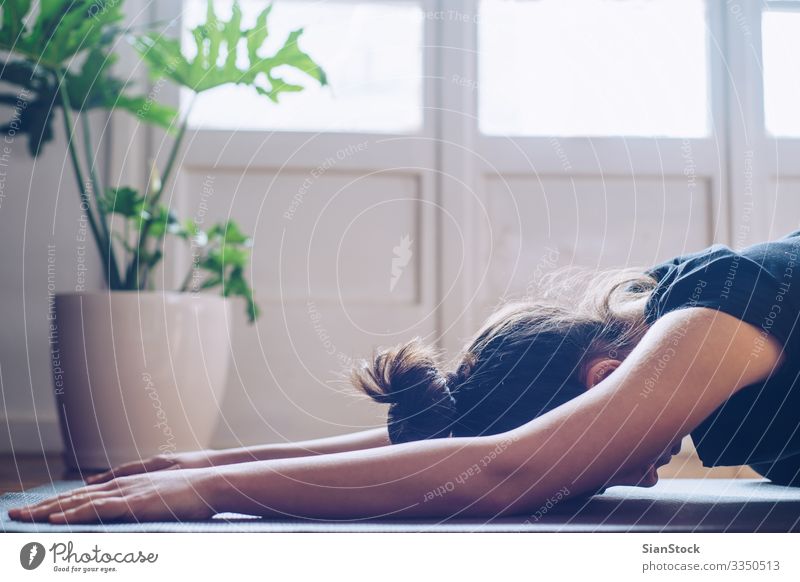 Woman doing yoga in the morning at her home. Pot Lifestyle Happy Beautiful Wellness Relaxation Meditation Sports Yoga Child Adults Plant Leaf Fitness Modern