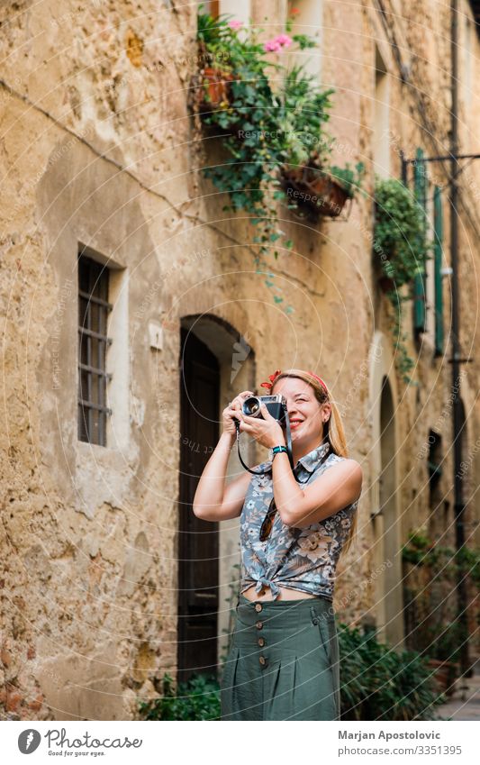 Young woman taking photo in old town in Tuscany, Italy Lifestyle Photographer Vacation & Travel Tourism Trip Sightseeing City trip Camera Human being Feminine