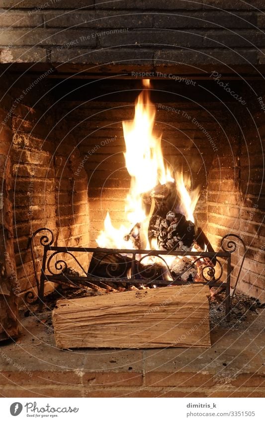 fire burning in old fireplace with charred bricks Winter Metal Brick Old Dirty Black wood Flame heat hearth ashes Rustic Second-hand Weathered Glow Spark Cozy