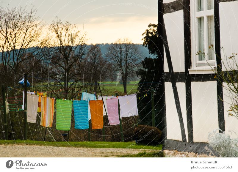 Colourful towels dry on a clothesline Garden Landscape Spring Weather Half-timbered house Cloth Clothesline Towels Wind Laundry Hang To swing Old Fresh Happy