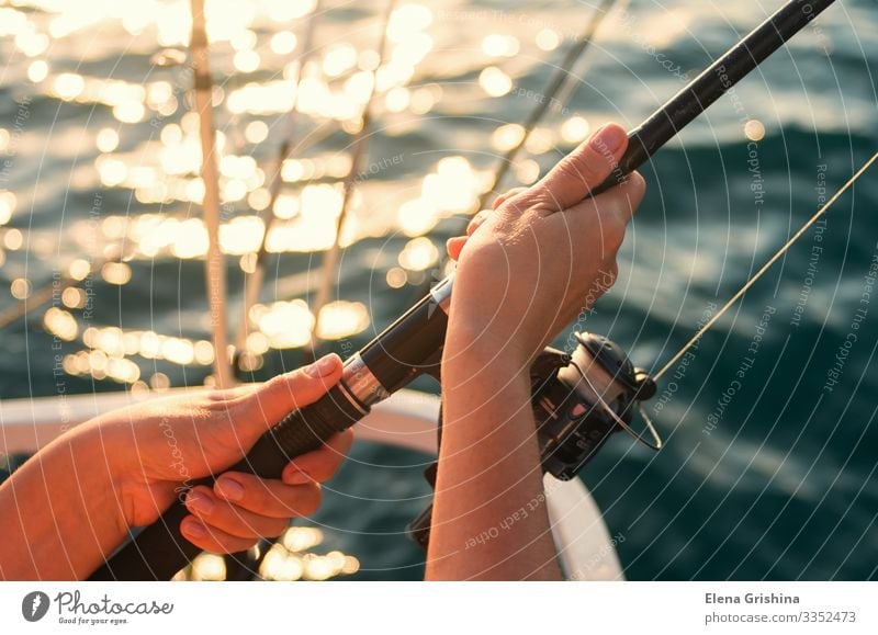 Female hands hold a fishing rod for fishing. Lifestyle Relaxation Leisure and hobbies Fishing (Angle) Vacation & Travel Trip Ocean Entertainment Woman Adults