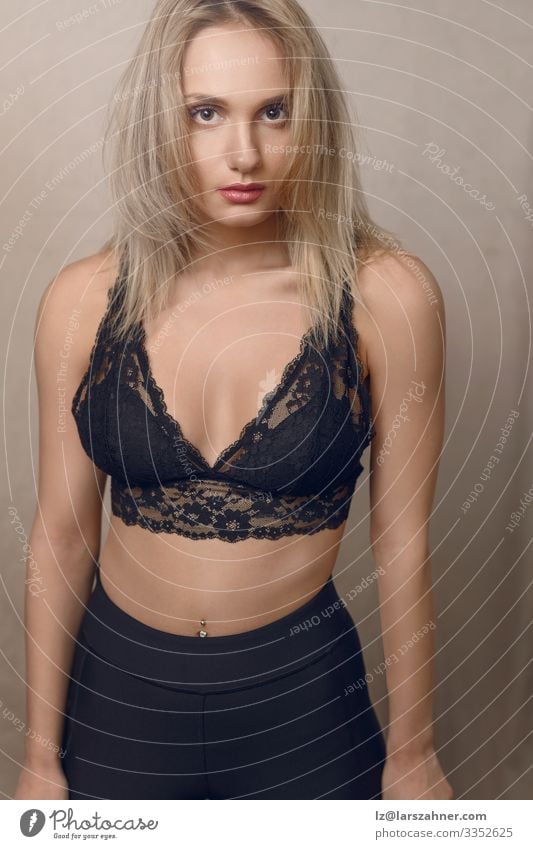 Young blond woman in lacy black lingerie - a Royalty Free Stock
