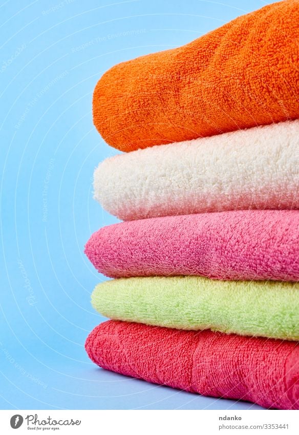 stack of colored cotton terry folded towels Lifestyle Design Body Relaxation Spa Massage Cloth Fresh Modern New Clean Soft Blue Green Pink Red White Colour