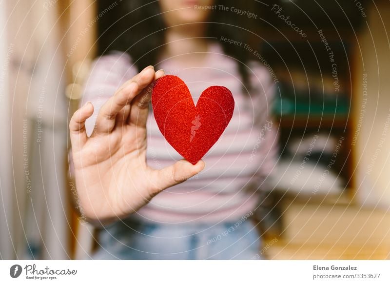 Young woman with red heart shaped cardboard on the hand. Feasts & Celebrations Valentine's Day Office work Human being Woman Adults Youth (Young adults) Hand