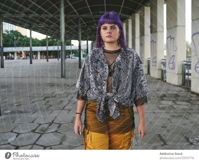 Woman with purple hair looking at camera woman stylish urban hairstyle construction shiny structure district confident fashion young model street human female