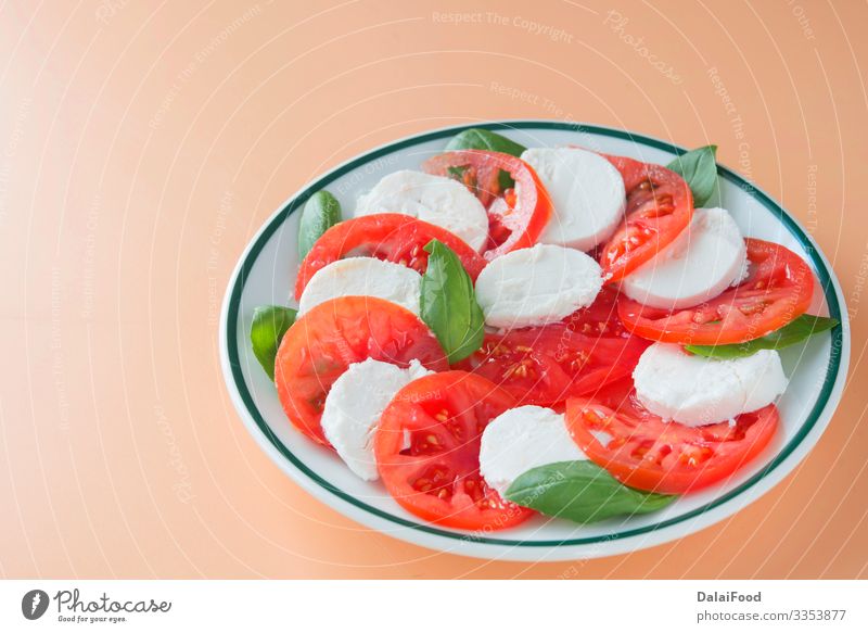 Caprese salad in brown background Cheese Vegetable Herbs and spices Nutrition Eating Diet Plate Table Fresh Red White Tradition Basil caprese salad Cooking food