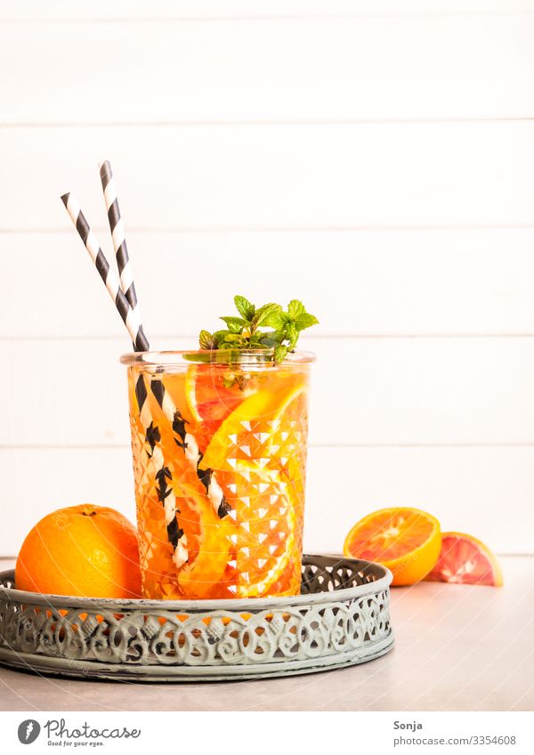 Summer drink with fresh oranges and peppermint Orange Herbs and spices Mint Organic produce Diet Beverage Cold drink Drinking water Lemonade Juice