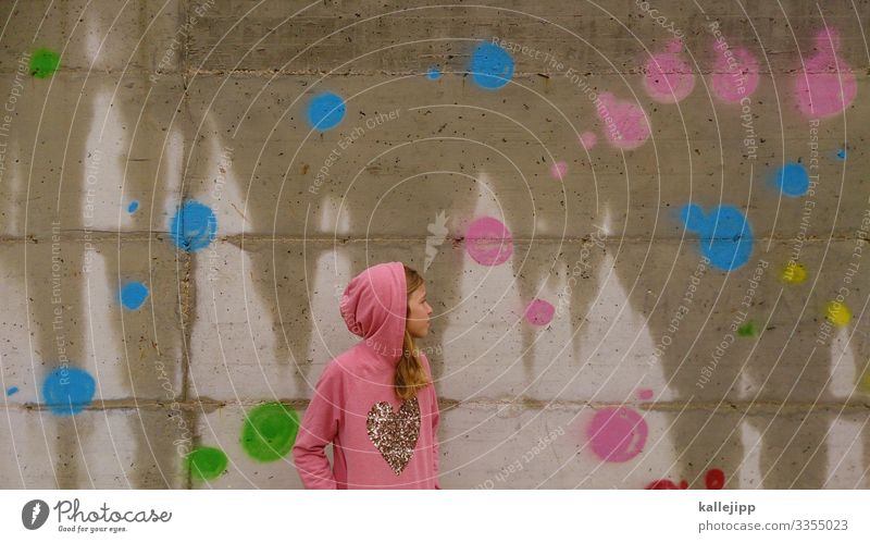 Teenager with hoodie in front of a dotted concrete wall Human being Feminine Girl Infancy Youth (Young adults) Life 1 Environment Nature Sun Spring Park