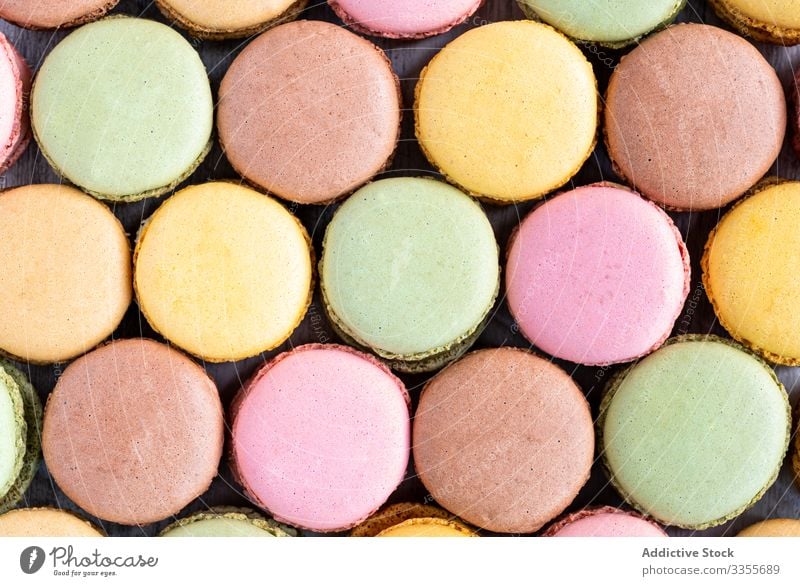 Fresh crunchy macaroons stack dessert colorful snack food wooden biscuit sweet gourmet assorted pastry confection traditional delicious tasty yummy sugar