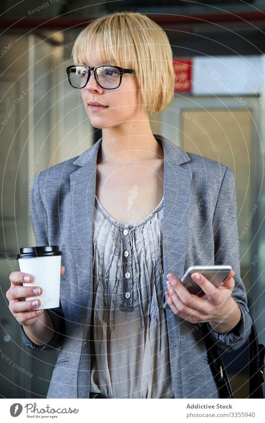 Businesswoman with coffee and smartphone businesswoman stylish young cup paper takeaway female professional person beautiful attractive entrepreneur elegant