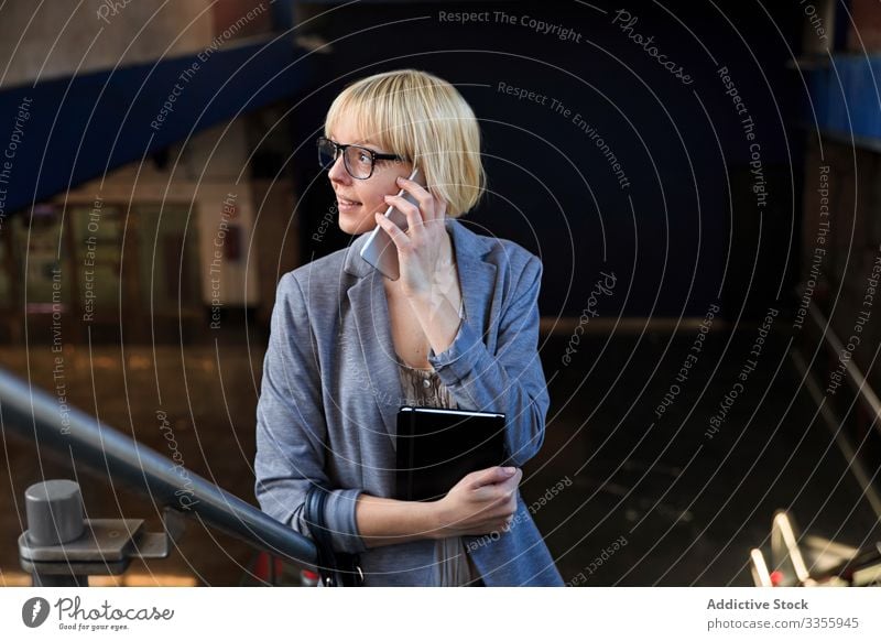Blonde businesswoman talking on smartphone stylish young notepad mobile connection communication conversation female professional person beautiful attractive