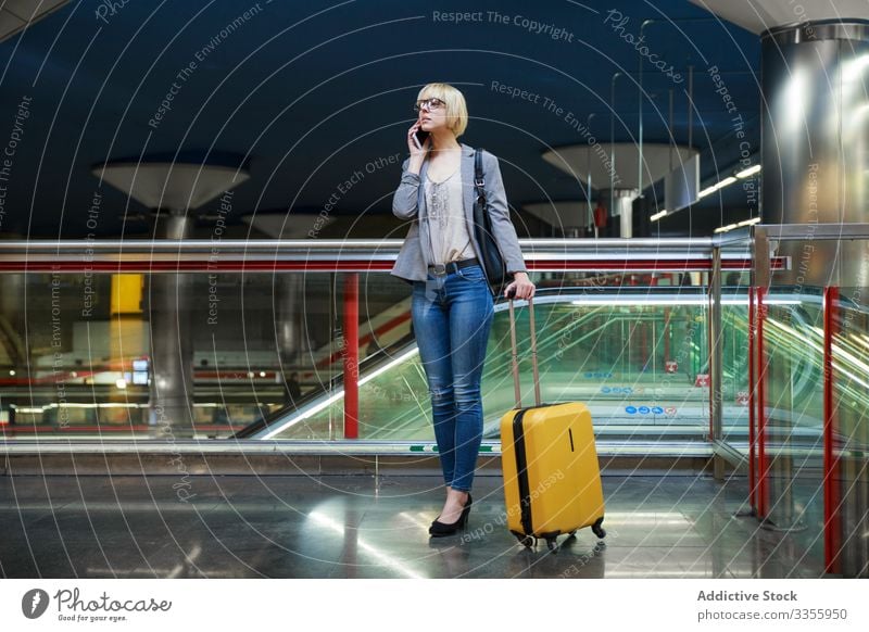 Businesswoman with luggage talking on phone businesswoman stylish young smartphone mobile connection female professional person beautiful baggage trip travel