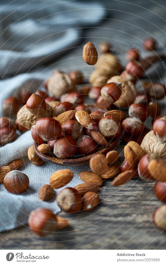 Brown ripe hazelnut on spoon at table brown healthy edible wooden filbert gathering heap ingredient natural harvest organic raw seed food snack linen tasty