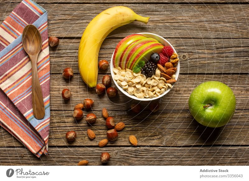 Apple and banana with nuts on wooden table apple super food healthy fresh towel breakfast cereal diet nutrition organic meal spoon fruit morning variety