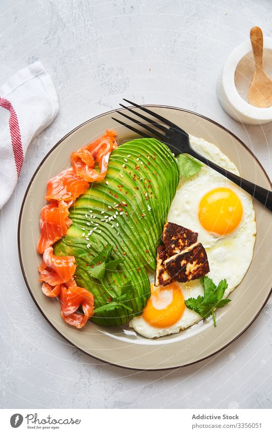 Healthy breakfast with fried eggs and avocado plate salmon fresh healthy food natural fish dish slice appetizing culinary brunch diet vegetarian ingredient