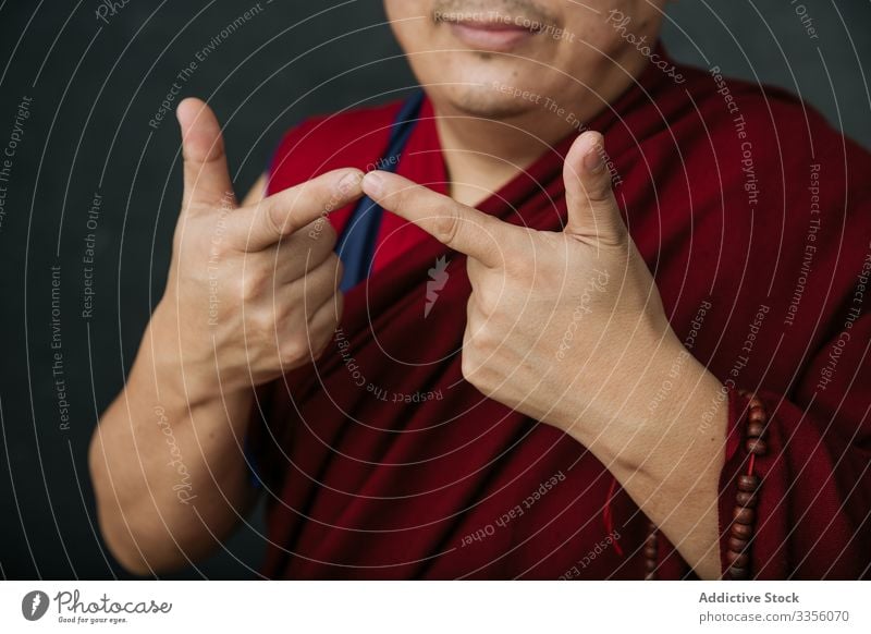 Buddhist monk with mudra hands gesture buddhist pray religion symbol traditional tibet red culture spirituality faith belief asia authentic holy sacred mantra