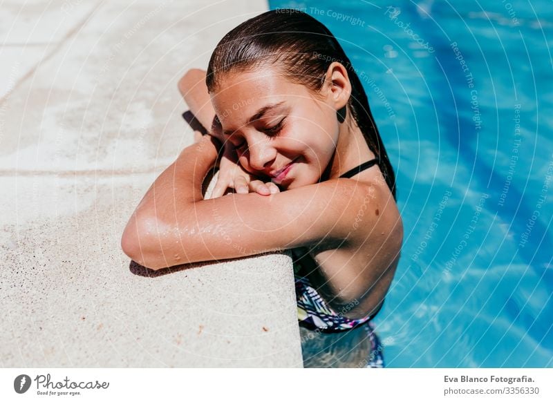 beautiful kid girl at the pool, summertime Sunlight Day Exterior shot young Swimwear water enjoyment swimming kids cheerful Action Playful Caucasian healthy