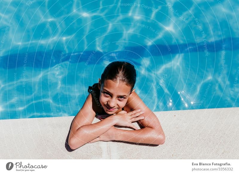 beautiful kid girl at the pool, summer time Sunlight Day Exterior shot young Swimwear water swimming enjoyment kids cheerful Playful Caucasian Blue healthy Cute