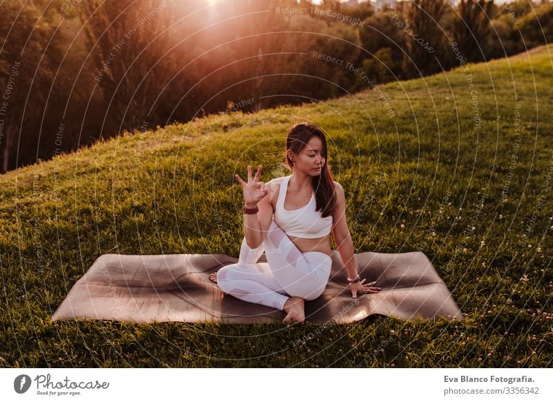 young beautiful asian woman doing yoga in a park at sunset. Yoga and healthy lifestyle concept Youth (Young adults) Woman Summer Happy enjoyment Sports