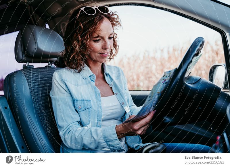 young beautiful woman reading a map in a car. travel concept Map Reading Woman Youth (Young adults) Driving Car Sunbeam Sunglasses Vacation & Travel Traveling