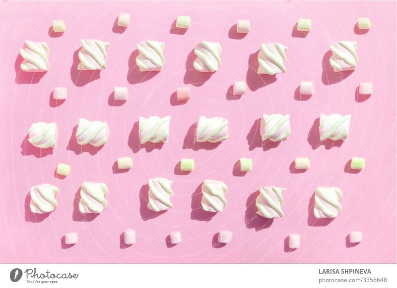 Sweet beze marshmallows on pink. Top view Dessert Winter Small Delicious Soft Pink White Colour sweet candy colorful flat background lay marshmellow fluffy food