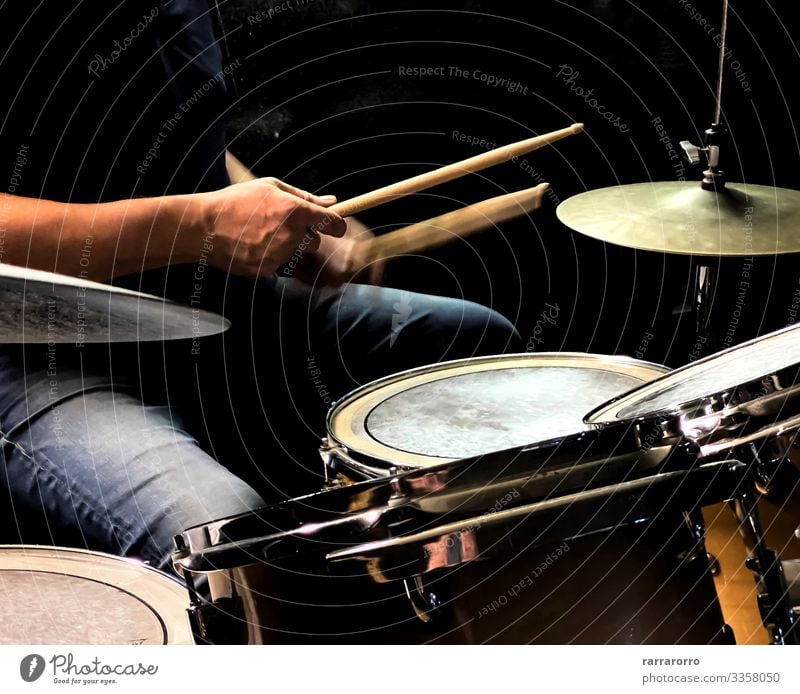 a drummer while playing the drums Playing Entertainment Music Human being Man Adults Hand Concert Band Musician Drum set Rock Metal Dark Modern Black action