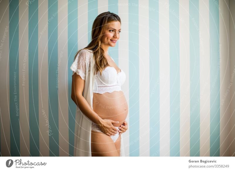 Pregnant woman wearing lingerie and posing in the room Luxury Elegant Happy Beautiful Human being Young woman Youth (Young adults) Woman Adults Parents Mother 1