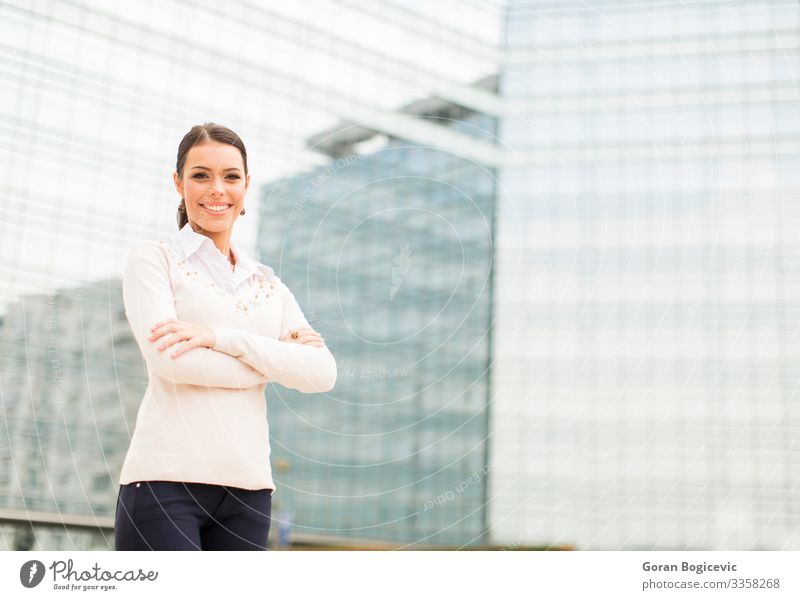 Young business woman in front of office building Lifestyle Style Happy Beautiful Success Office Business Career Human being Young woman Youth (Young adults)
